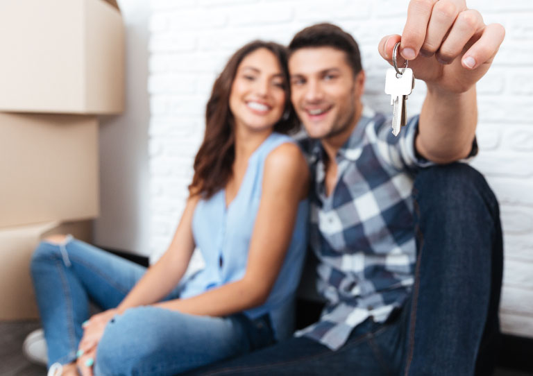 pareja feliz con llave de primer vivienda